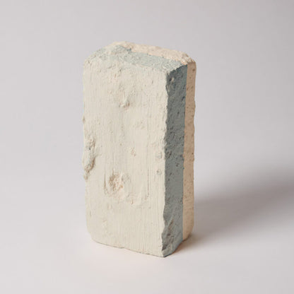 Concrete block with visible layers on a white background