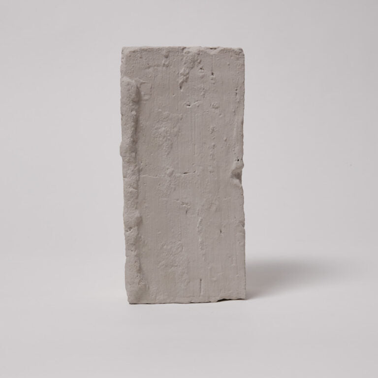 Rectangular concrete block on a light gray background