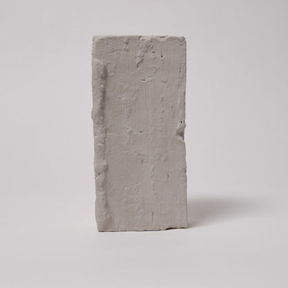 Rectangular concrete block on a light gray background
