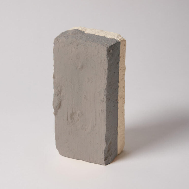 Concrete block with a gradient of gray and beige on a white background
