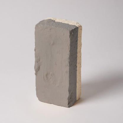 Concrete block with a gradient of gray and beige on a white background