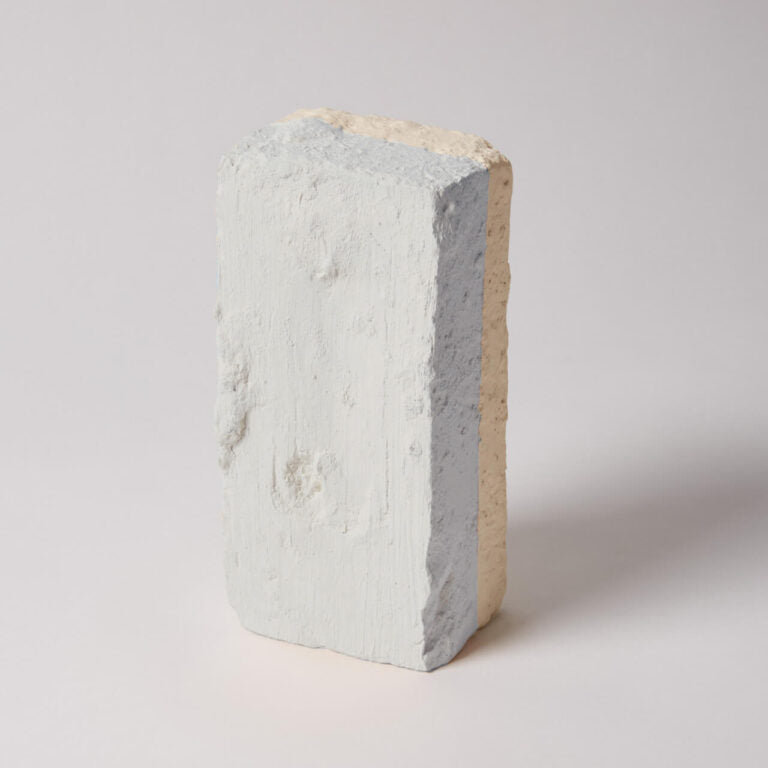 Concrete block with a gradient of colors on a light gray background