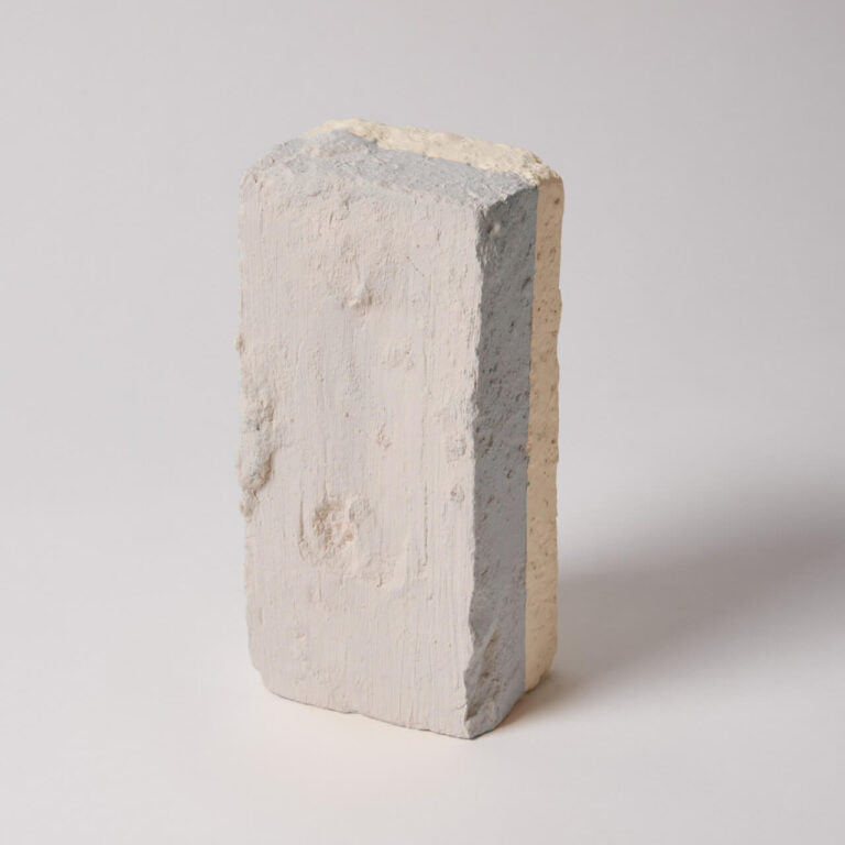 Concrete block with a gradient of colors on a light gray background