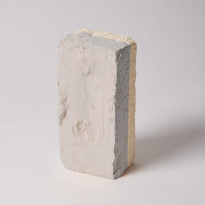 Concrete block with a gradient of colors on a light gray background