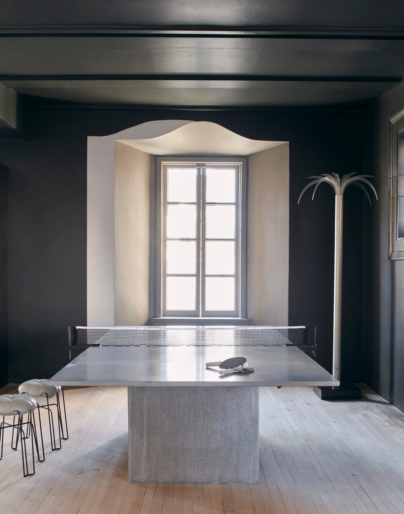 Modern room with a ping pong table and dark walls