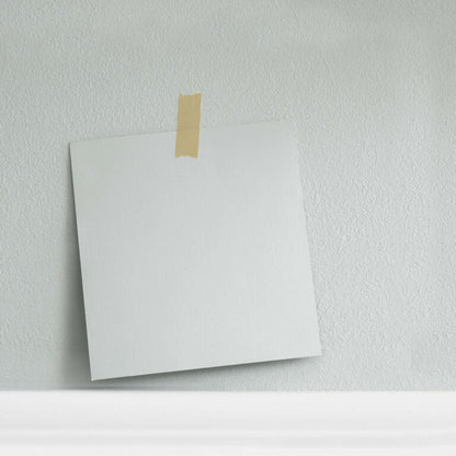 White envelope with gold tape on a light gray background