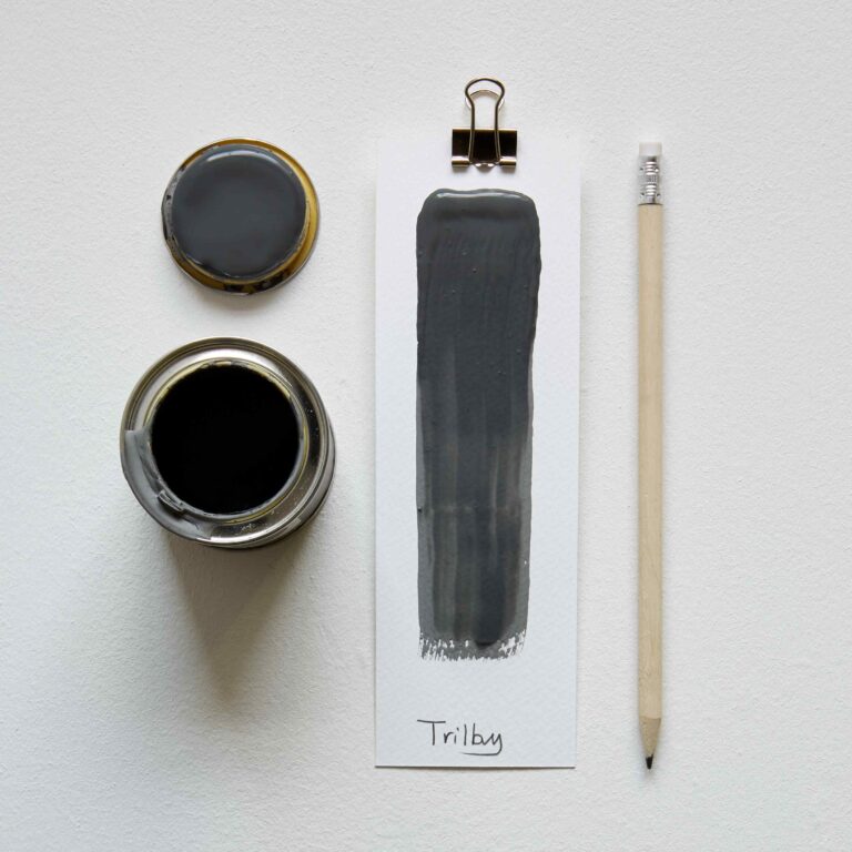 Black paint can, brush stroke on paper, pencil, and clip on a white background