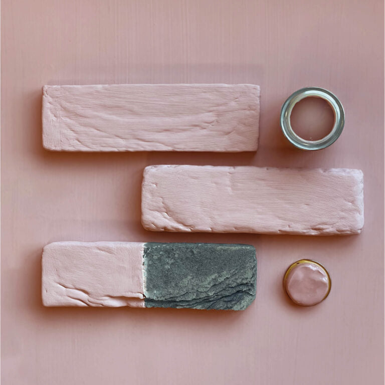 Wooden planks with paint samples on a pink background