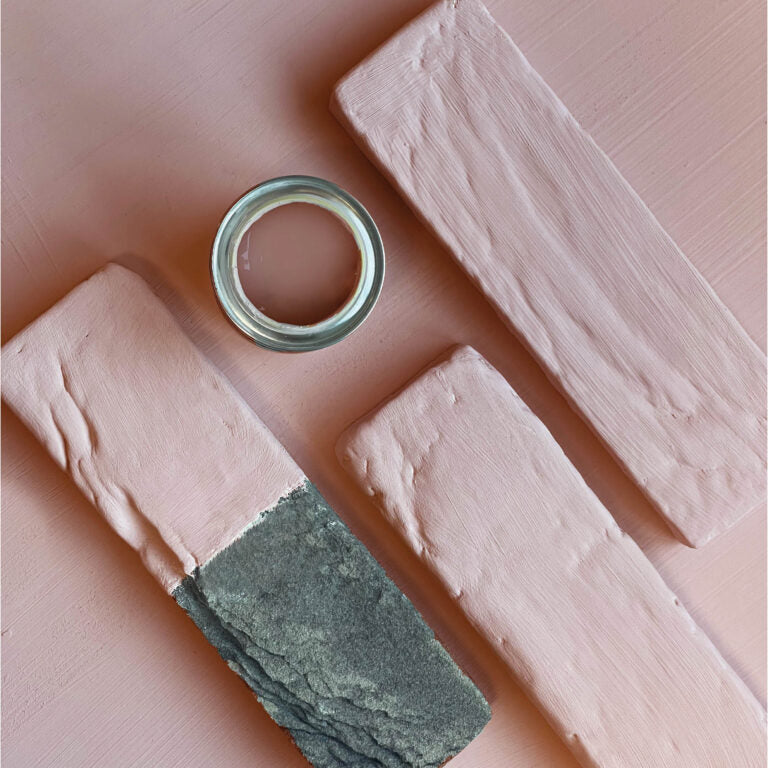 Close-up of a metallic ring on pink and green textured blocks