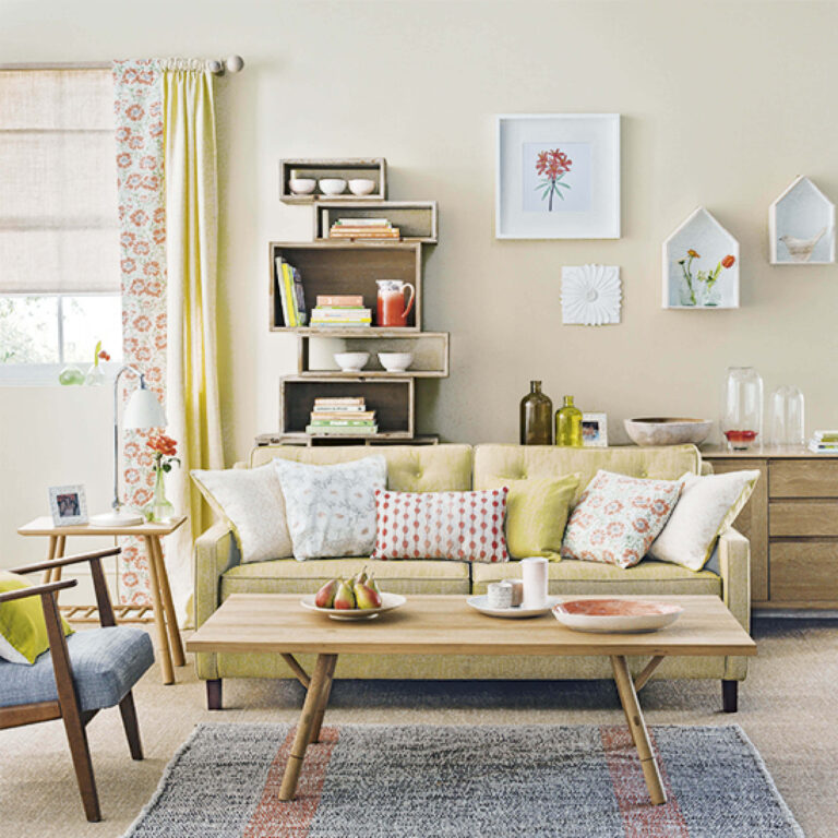 Living room with a beige sofa, wooden coffee table, and decorative elements.