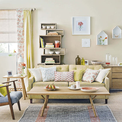 Living room with a beige sofa, wooden coffee table, and decorative elements.