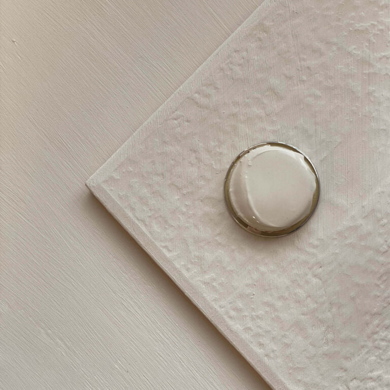 Close-up of a ring on a textured beige surface