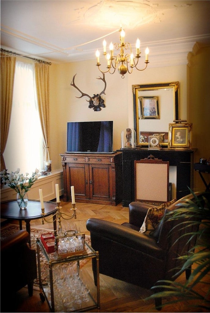 Living room with a television, armchair, and decorative items.