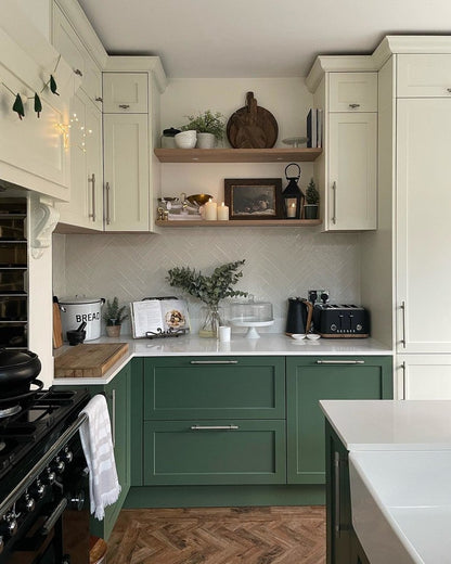 Modern kitchen with green lower cabinets and white upper cabinets.