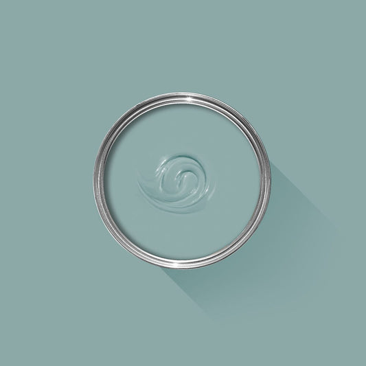 Clear glass lid with a metal rim on a light blue background