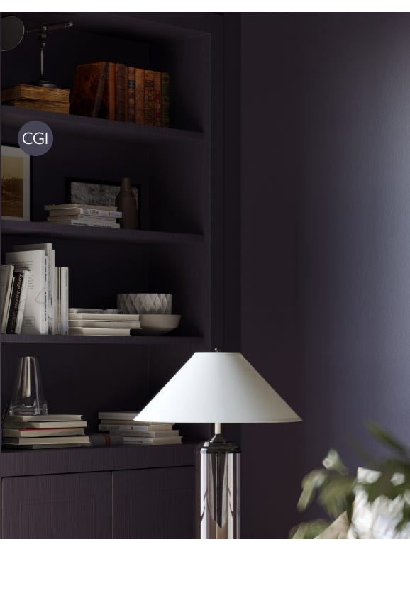 Floor lamp with white shade in front of a dark purple wall with shelves containing books and decor items.