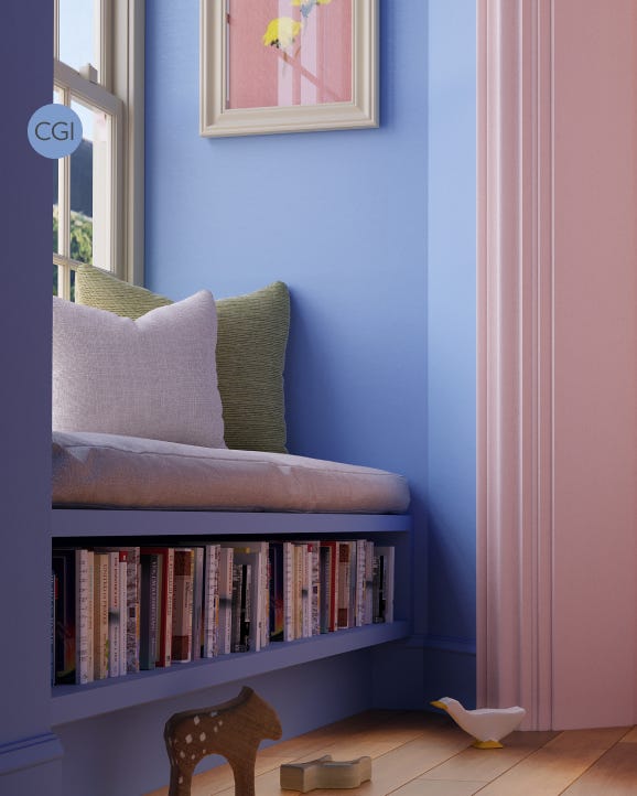Nook with cushions, books, and a small table against a blue wall.