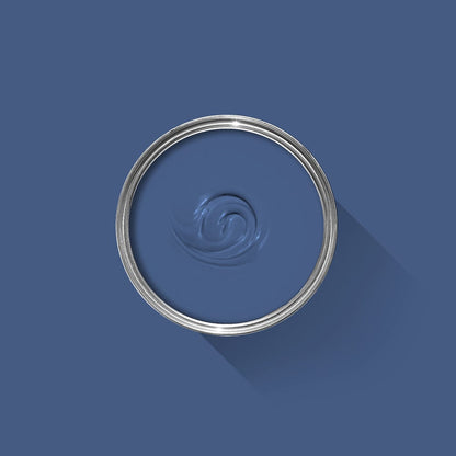 Blue paint swatch with a silver lid on a blue background