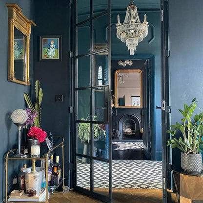 Luxurious interior with a chandelier, mirror, and decorative items in a stylish room.