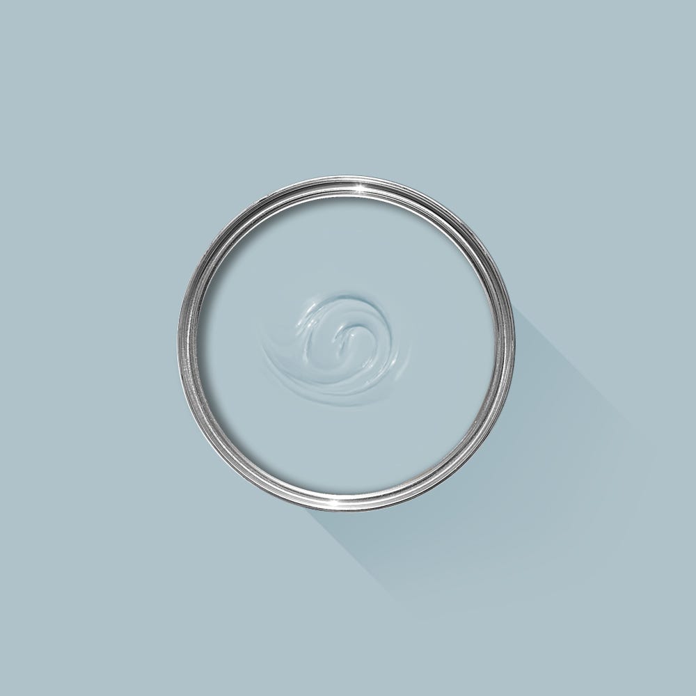 Clear glass lid with metal rim on a light blue background