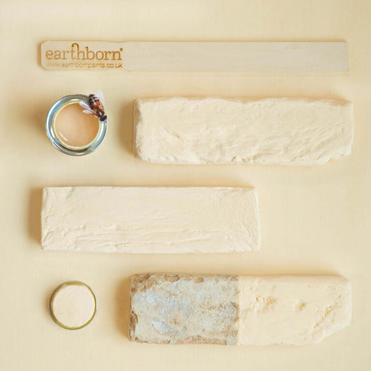 Earthenware clay items including rings and bars on a beige background with 'earthborn' branding.