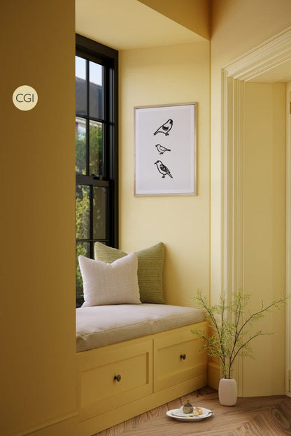 Nook with window seat, cushions, and a plant in a room with yellow walls.