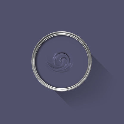 Clear glass container with a swatch of dark blue paint on a purple background
