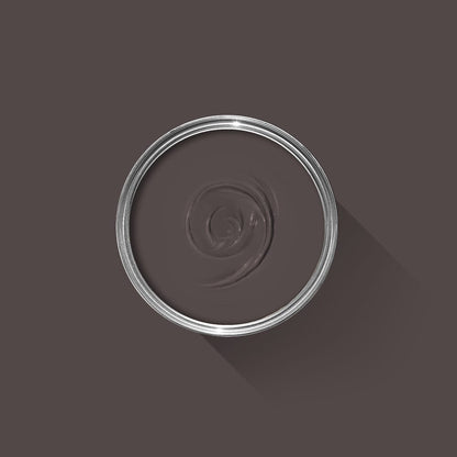 Clear glass bowl with a dark brown liquid on a dark gray background