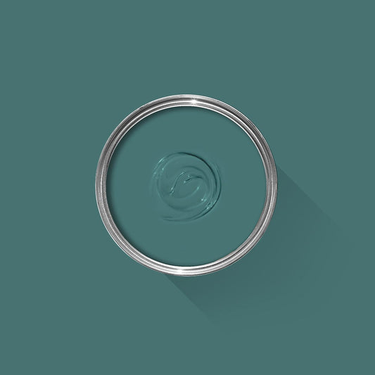 Teal paint sample with a silver lid on a teal background