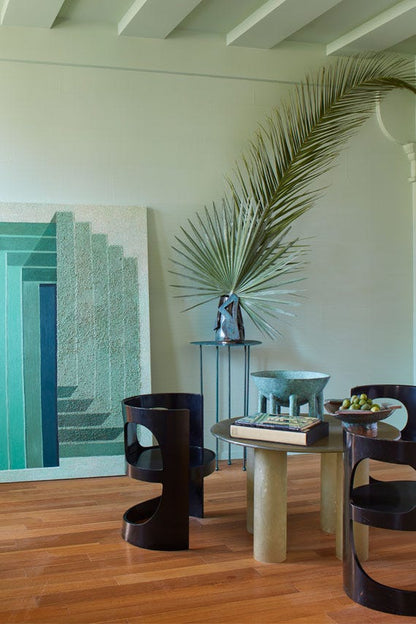 Modern interior with a table, chairs, and decorative elements in a room.