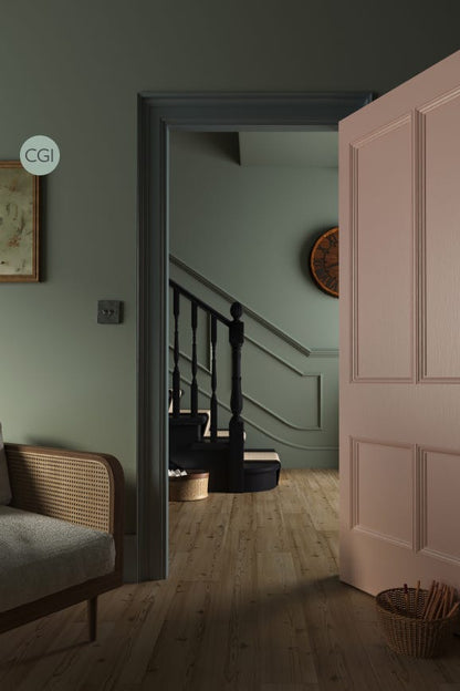 Staircase with a pink door and wicker chair in a home interior setting.