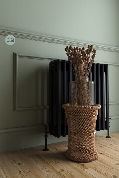 Decorative vase with dried plants on a woven stool against a wall with a radiator.
