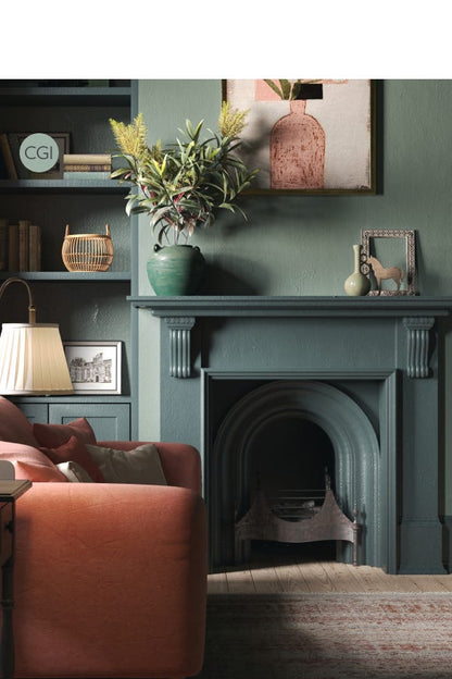 Living room with a green fireplace, orange sofa, and decorative items.