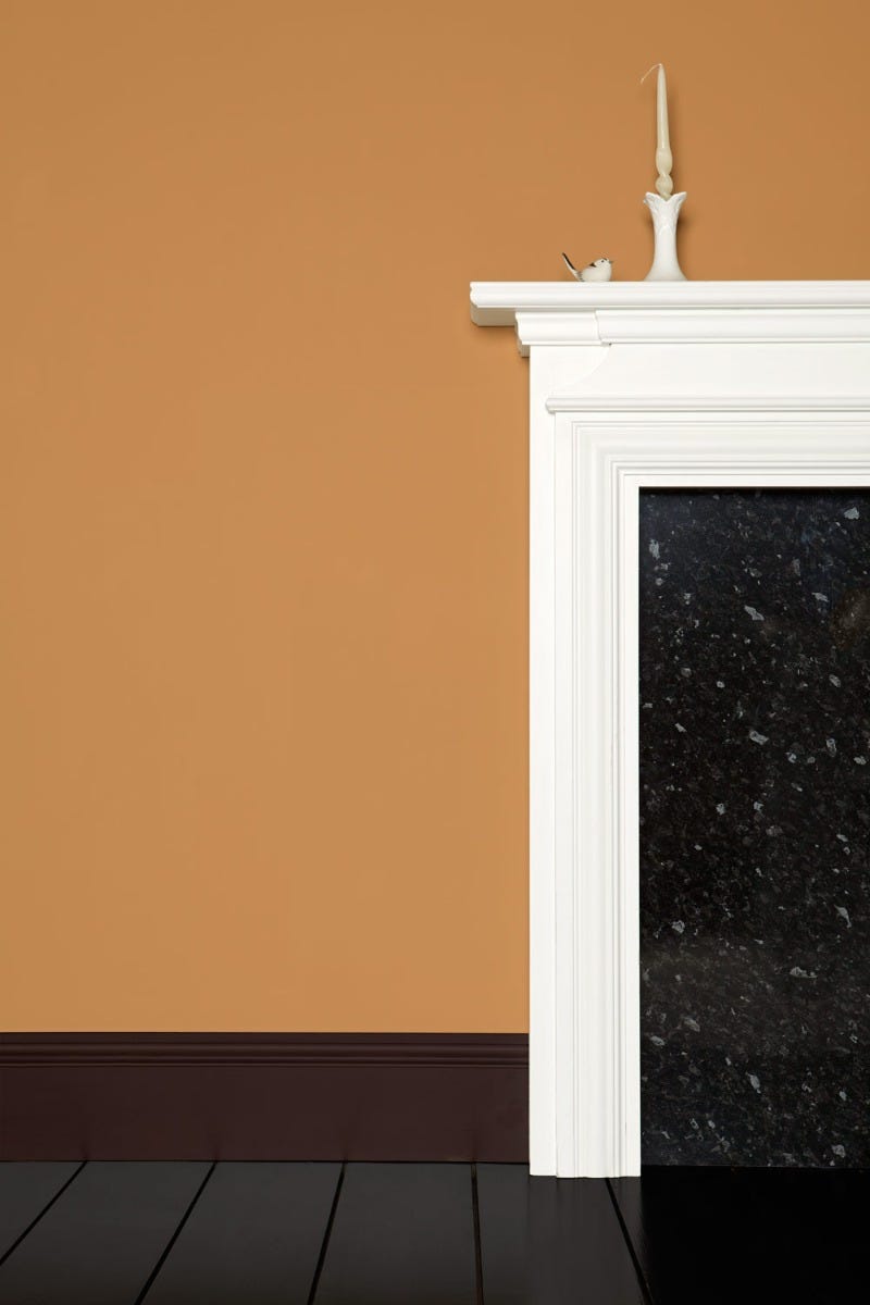 White fireplace against a brown wall