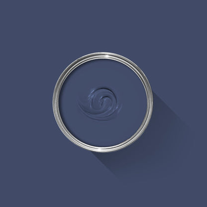 Close-up of a blue paint swatch with a silver ring on a dark blue background