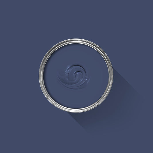 Close-up of a blue paint swatch with a silver ring on a dark blue background