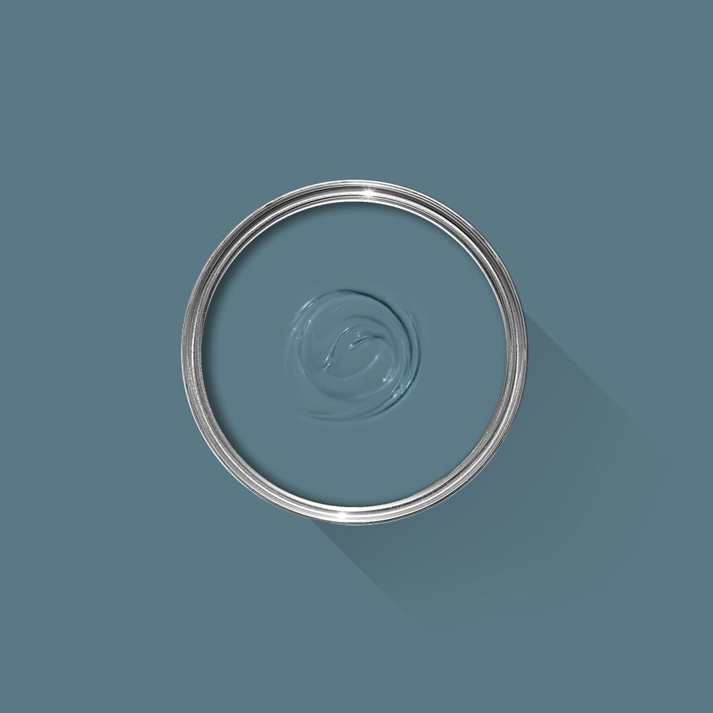 Clear liquid in a circular container on a teal background