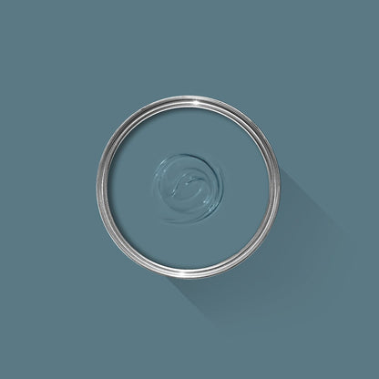 Clear liquid in a circular container on a teal background