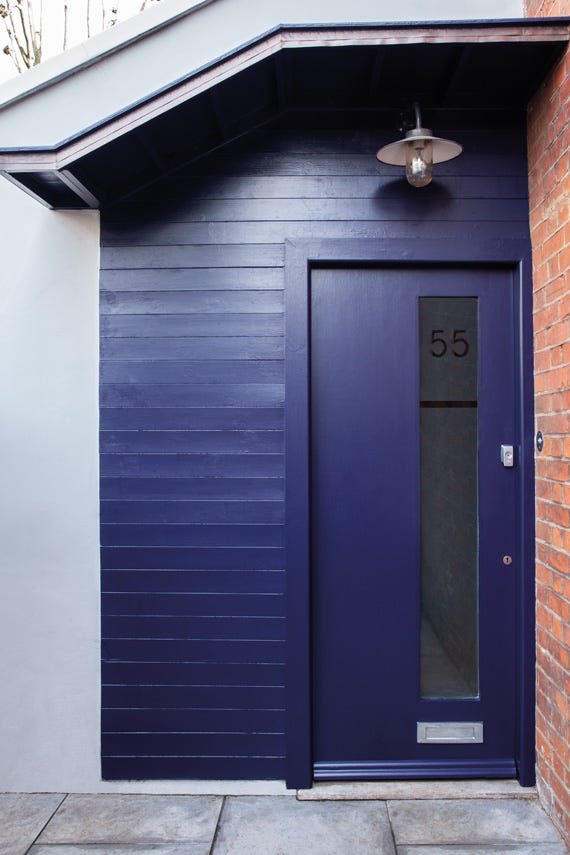 Modern purple front door with glass panel and number 55 on a house exterior.