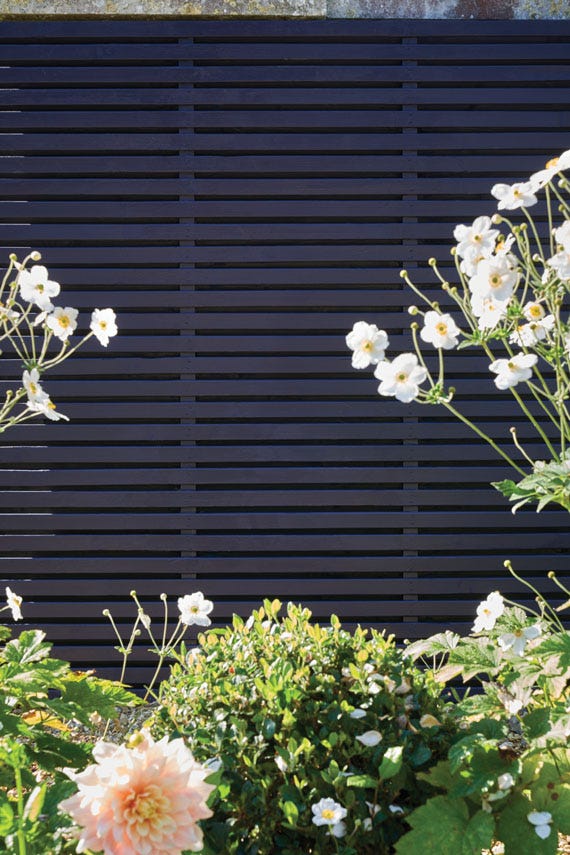 Floral arrangement in front of a dark wooden panel