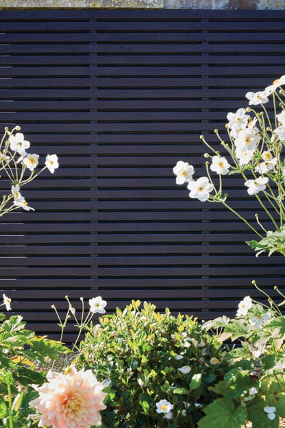 Floral arrangement in front of a dark wooden panel