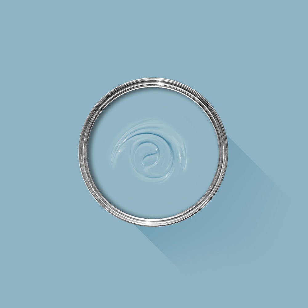 Clear glass bowl with metal rim on a light blue background