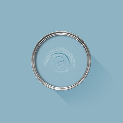 Clear glass bowl with metal rim on a light blue background