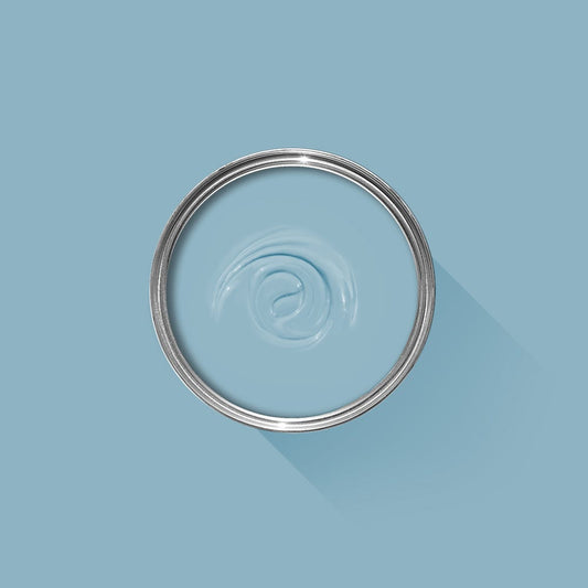 Clear glass bowl with metal rim on a light blue background